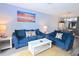 Bright living room offering beach artwork and comfortable blue sofas at 3401 Dunes St. # A3, North Myrtle Beach, SC 29582