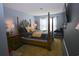 Comfortable main bedroom featuring a four-poster bed, stylish rug, and ample natural light at 3401 Dunes St. # A3, North Myrtle Beach, SC 29582