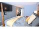 Stylish main bedroom featuring a four-poster bed, TV, and soothing decor at 3401 Dunes St. # A3, North Myrtle Beach, SC 29582