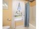 Bathroom features a shower/tub combo, with white curtains, and a window providing ample natural light at 3910 Stillwood Dr., Myrtle Beach, SC 29588