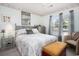 Cozy bedroom features a queen-sized bed with an ornate headboard, mirror, and soft natural light at 3910 Stillwood Dr., Myrtle Beach, SC 29588
