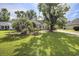Charming home with lush front yard, mature trees, well-maintained lawn, and inviting landscaping at 3910 Stillwood Dr., Myrtle Beach, SC 29588