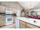 Bright kitchen features an island, white appliances, and a dining area with sliding glass doors to the exterior at 3910 Stillwood Dr., Myrtle Beach, SC 29588