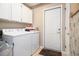Functional laundry room equipped with a washer, dryer, storage cabinets, and easy exterior access at 3910 Stillwood Dr., Myrtle Beach, SC 29588