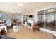 Bright sunroom features a fireplace, views of the exterior, and comfortable seating with plentiful natural light at 3910 Stillwood Dr., Myrtle Beach, SC 29588