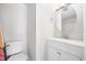 A clean bathroom featuring a modern vanity with a round mirror and a toilet at 4000 North Ocean Blvd. # 1002, North Myrtle Beach, SC 29582