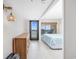 Relaxing bedroom featuring a bed, dresser, and balcony access with ocean views at 4000 North Ocean Blvd. # 1002, North Myrtle Beach, SC 29582