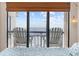A spectacular ocean view from the bedroom balcony with two white Adirondack chairs at 4000 North Ocean Blvd. # 1002, North Myrtle Beach, SC 29582