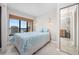 Tranquil bedroom with ocean view balcony, complemented by rattan shades and soft lighting at 4000 North Ocean Blvd. # 1002, North Myrtle Beach, SC 29582