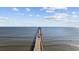 Wide angle view of the wooden fishing pier leading out to the ocean on a beautiful day with puffy white clouds at 4000 North Ocean Blvd. # 1002, North Myrtle Beach, SC 29582