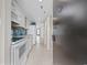 Galley kitchen featuring modern appliances and stylish blue backsplash at 4000 North Ocean Blvd. # 1002, North Myrtle Beach, SC 29582
