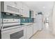 Galley kitchen featuring modern appliances and stylish blue backsplash at 4000 North Ocean Blvd. # 1002, North Myrtle Beach, SC 29582
