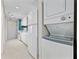 A bright kitchen with white cabinets and appliances, including a stacked washer and dryer at 4000 North Ocean Blvd. # 1002, North Myrtle Beach, SC 29582