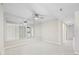 A wide living room with a ceiling fan and floor to ceiling mirror with view to the kitchen at 4000 North Ocean Blvd. # 1002, North Myrtle Beach, SC 29582
