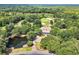 Stunning aerial view of home with pond, landscaped grounds, and surrounded by the community's golf course at 423 Chapman Loop, Pawleys Island, SC 29585