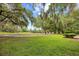 Well-manicured green backyard with mature trees and landscaping at 423 Chapman Loop, Pawleys Island, SC 29585