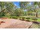Well-kept backyard featuring a brick patio, green grass, and mature trees at 423 Chapman Loop, Pawleys Island, SC 29585