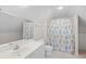 Cozy attic bathroom with a shower featuring patterned curtain and tiled floor at 423 Chapman Loop, Pawleys Island, SC 29585