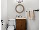 Charming powder room featuring a decorative mirror and wooden vanity with marble countertop at 423 Chapman Loop, Pawleys Island, SC 29585
