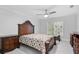 Ornate bedroom with ceiling fan, plush carpet, and large window with natural light at 423 Chapman Loop, Pawleys Island, SC 29585