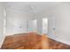 A spacious bedroom featuring hardwood floors and a view of the ensuite bathroom at 423 Chapman Loop, Pawleys Island, SC 29585