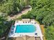 Aerial view of a sparkling community pool with lounge chairs and tables, surrounded by lush landscaping at 423 Chapman Loop, Pawleys Island, SC 29585