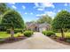 Beautiful brick home with a well-manicured lawn and a long driveway leading to a two-car garage at 423 Chapman Loop, Pawleys Island, SC 29585
