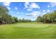 Scenic golf course view featuring a well-manicured green and lush fairway surrounded by mature trees at 423 Chapman Loop, Pawleys Island, SC 29585