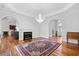 Spacious living room featuring a fireplace, wood floors and elegant lighting fixture at 423 Chapman Loop, Pawleys Island, SC 29585