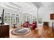 Bright sunroom featuring white columns, many windows and hardwood flooring at 423 Chapman Loop, Pawleys Island, SC 29585