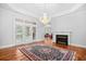 Elegant living room with a fireplace, wood floors and French doors to the patio at 423 Chapman Loop, Pawleys Island, SC 29585