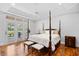 Main bedroom with hardwood floors, tray ceilings, and French doors to the outside at 423 Chapman Loop, Pawleys Island, SC 29585