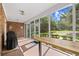 Screened-in patio with brick flooring, a grill, and a wood table overlooking the yard at 423 Chapman Loop, Pawleys Island, SC 29585