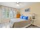 Serene bedroom features a large window with natural light, a queen bed, and a dresser at 430 Ocean Creek Dr. # 2534, Myrtle Beach, SC 29572