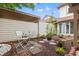 A quaint courtyard with white chairs, rock features, and greenery creates a relaxing and inviting outdoor space at 430 Ocean Creek Dr. # 2534, Myrtle Beach, SC 29572