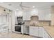Bright kitchen featuring white cabinetry, stainless steel appliances, and stone countertops for a modern aesthetic at 430 Ocean Creek Dr. # 2534, Myrtle Beach, SC 29572