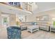 An airy living room with high ceilings and a loft showcases a comfortable seating arrangement and modern decor at 430 Ocean Creek Dr. # 2534, Myrtle Beach, SC 29572
