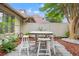 Charming patio with white outdoor dining set, surrounded by lush plants and mulch beds, creates a peaceful retreat at 430 Ocean Creek Dr. # 2534, Myrtle Beach, SC 29572