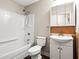 Bathroom with a shower-tub, vanity with cabinet, and mirrored cabinet, all with neutral earth-toned finishes at 4300 Crows Nest Ct., Myrtle Beach, SC 29579