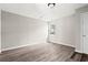 A light-filled bedroom features wood-look floors and a bright window at 4300 Crows Nest Ct., Myrtle Beach, SC 29579