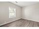 Sunlit bedroom showcases wood floors, a bright window, and neutral walls ready for personalization at 4300 Crows Nest Ct., Myrtle Beach, SC 29579
