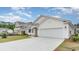 Beautiful home exterior with two-car garage, manicured lawn, and newly constructed home next door at 438 Clear Lake Dr., Conway, SC 29526