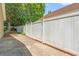 Backyard features a concrete patio with white fence and landscaped perimeter at 4406 Barcelona Ln., Little River, SC 29566