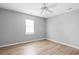 This bedroom features modern gray walls, neutral flooring, and a ceiling fan at 4406 Barcelona Ln., Little River, SC 29566