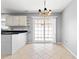 Cozy dining area with tile flooring, a chandelier, and sliding glass doors to the backyard at 4406 Barcelona Ln., Little River, SC 29566