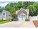 Welcoming home with an attached garage, landscaped front yard, and classic design elements at 4406 Barcelona Ln., Little River, SC 29566