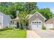 Charming home featuring an attached garage, cozy front porch, and landscaped front yard at 4406 Barcelona Ln., Little River, SC 29566