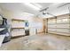 Spacious garage with pegboard, shelves, and a garage door with windows at 4406 Barcelona Ln., Little River, SC 29566