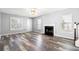 Bright living room featuring a fireplace, hardwood floors, and large windows with natural light at 4406 Barcelona Ln., Little River, SC 29566