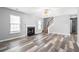 Spacious living room with a fireplace, hardwood floors, and large windows at 4406 Barcelona Ln., Little River, SC 29566